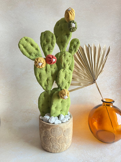 Opuntia in wool fabric complete with white ceramic vase and decorative stones.