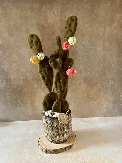 Opuntia in wool fabric complete with white ceramic vase and decorative stones.