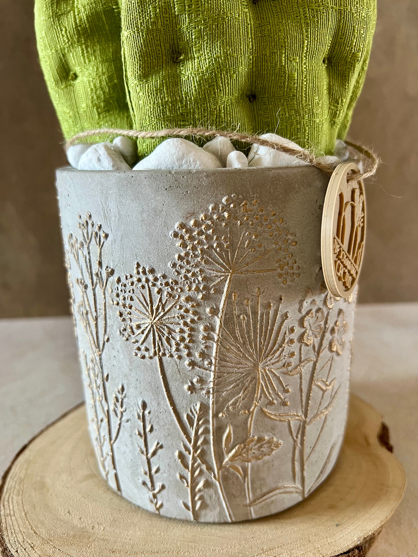 Opuntia in wool fabric complete with white ceramic vase and decorative stones.
