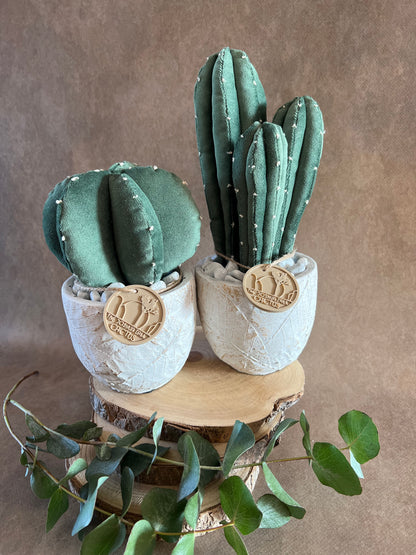 Coppia di composizioni ricamate in vellutino verde, vaso in cemento con motivi a foglia, h circa 19 e 27 cm