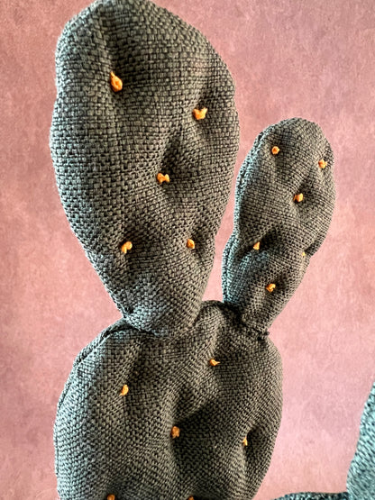 Opuntia in wool fabric complete with white ceramic vase and decorative stones.